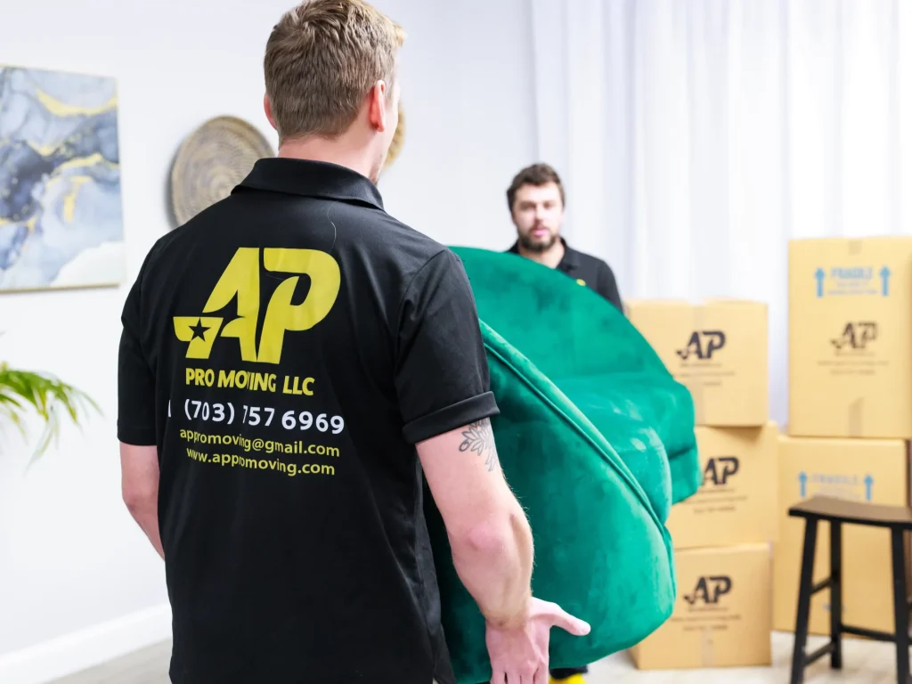 AP Pro Moving team members moving a sofa as part of the local moving checklist