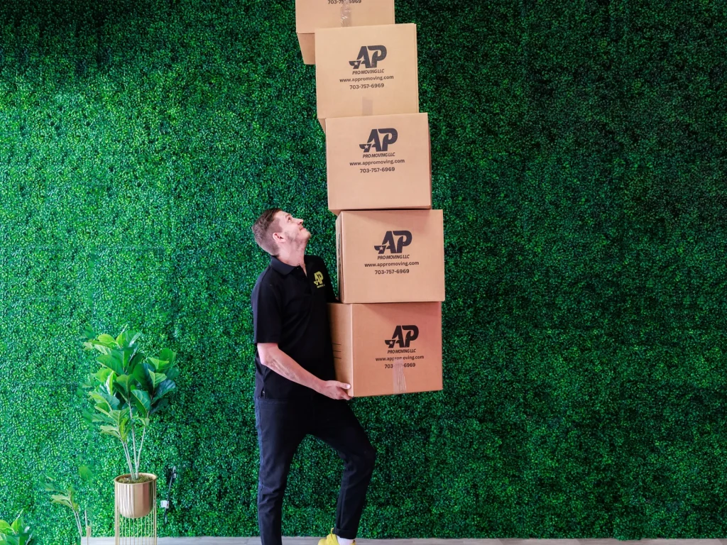 AP Pro Moving employee with a group of boxes ready to learn how to downsize for a move.